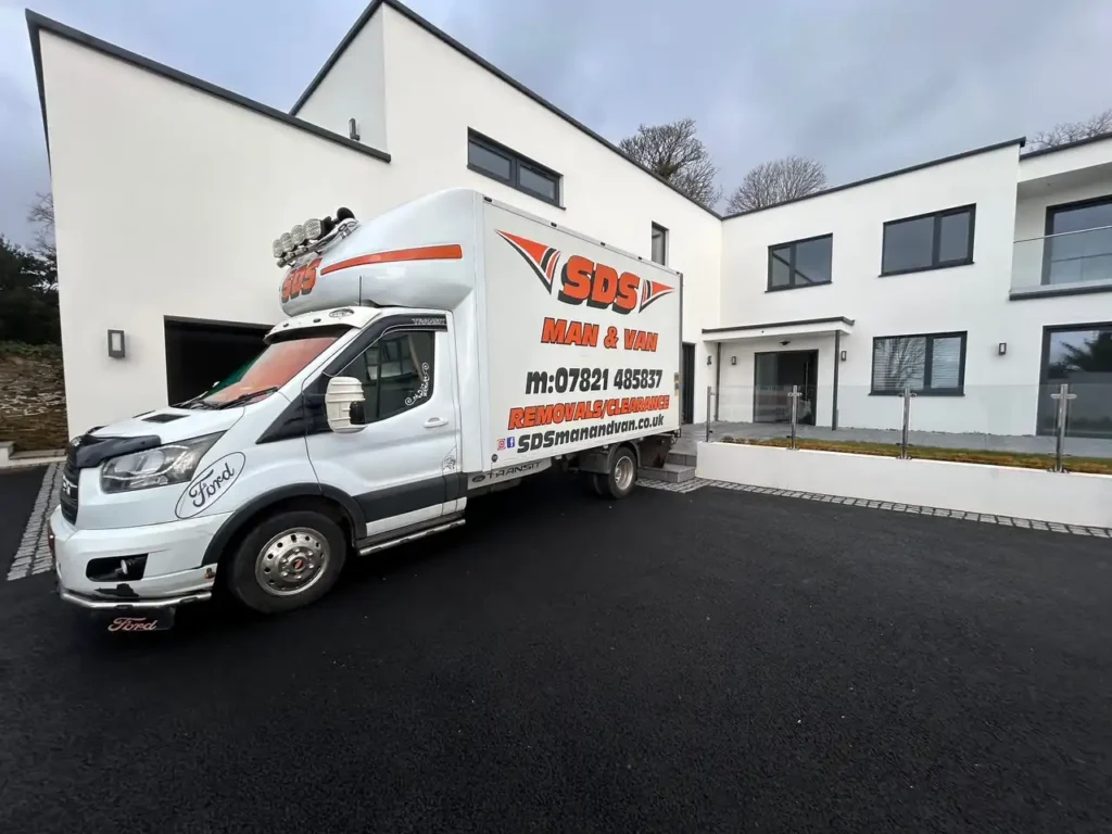 SDS Man and Van removal truck parked outside a modern home in Plymouth