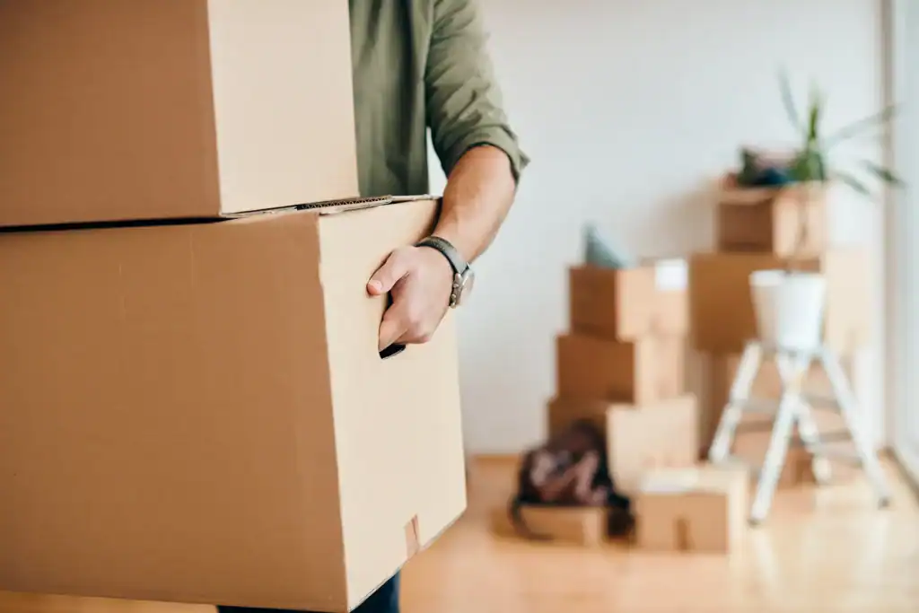 Person carrying moving boxes supplied by SDS Man and Van in Plymouth Devon for local and UK-wide removals